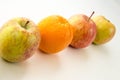 Line of apples with one orange Royalty Free Stock Photo