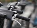 Line of bicycle handlebars in a row for city bike rental.