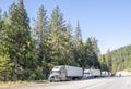 Line of the big rigs semi trucks with semi trailers standing on the road shoulder for truck drivers rest Royalty Free Stock Photo