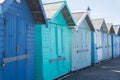 Line of blue and green painted wooden beach huts Royalty Free Stock Photo