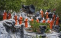 A line of Buddhist monk statues approaching the The Golden Temple at Dambulla, Sri Lanka. Royalty Free Stock Photo