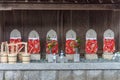 Line of Buddhist relics with red bibs, Umiyama, Fukui Prefecture, Japan