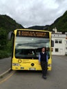 Line bus driver sitting in the driving seat with blue uniform on city bus