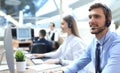 Line of call centre employees working on computers