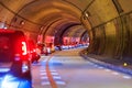 Line of cars stopped in heavy gridlock traffic in curved tunnel Royalty Free Stock Photo