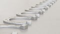 Linear Array of Chrome Horse Shoes on a Light Gray Surface