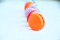 Line of colorful macarons on a white stone background. Royalty Free Stock Photo