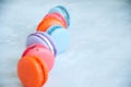 Line of colorful macarons on a white stone background. Royalty Free Stock Photo