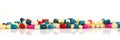 Line of colorful pills and medication on white panoramic background Royalty Free Stock Photo