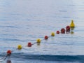 Line of plastic buoys delimit an area in the sea Royalty Free Stock Photo