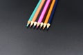 Line of coloured pencils on a black background Royalty Free Stock Photo