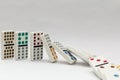 Line of colourful falling dominos on white background.