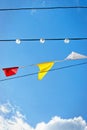 Line of colourful festival flags and lamps against blue sky Royalty Free Stock Photo