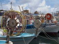 A line of colourful traditional fishing boats moored in paphos harhour in cyprus with blue summer sky and clouds