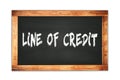 LINE OF CREDIT text written on wooden frame school blackboard