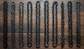 A Line of Dark Chains on a Rustic Wood Background