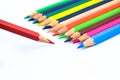 Line of different colored wood pencil crayons pointing at a red color pencil Royalty Free Stock Photo