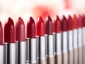 Line of different lipsticks. Red lipstick background. Commercial banner of various lipsticks of different shades Over light