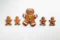 Line of different sizes of Gingerbread men isolated on white background. Christmas tradition. Top view Royalty Free Stock Photo
