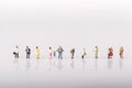 Line of diverse tiny miniature model people Royalty Free Stock Photo