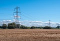 Line of electricity pylons in countryside Royalty Free Stock Photo