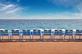 Line of empty chairs on the English Promenade in the city of Nice France Royalty Free Stock Photo