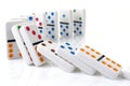 Falling colorful dominoes on a white surface Royalty Free Stock Photo