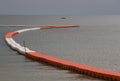 Line of floating orange and white buoys for marking safety zone Royalty Free Stock Photo