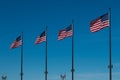 Line of Four American Flags Waving on Blue Sky Royalty Free Stock Photo