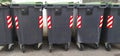 Line of grey dumpsters on sideway Royalty Free Stock Photo