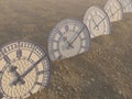 A line of half buried antique clocks