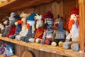 a line of handmade sock puppets displayed on a wooden shelf