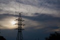 A line of high-voltage cables against a gray sky with clouds. Royalty Free Stock Photo