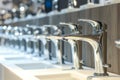 line of highend designer faucets under bright store lighting