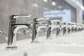 line of highend designer faucets under bright store lighting