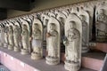 Line of hundreds of Buddha jizo statues at Reisenji Buddhist Temple Royalty Free Stock Photo