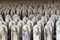 Line of hundreds of Buddha jizo statues at Reisenji Buddhist Temple Royalty Free Stock Photo