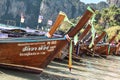 Line of long tail boats parked on a beach in Krabi Thailand