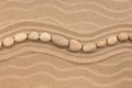 Line made of white stones lying wavy, on sand dune. Royalty Free Stock Photo