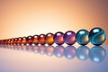 a line of marbles in gradient color order on a reflective surface Royalty Free Stock Photo
