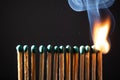 Line of matches without distance where they are lit one by one spreading the fire. COVID-19 spreads the same if there is not Royalty Free Stock Photo