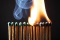 Line of matches without distance where they are lit one by one spreading the fire. COVID-19 spreads the same if there is not Royalty Free Stock Photo