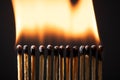 Line of matches without distance where they are lit one by one spreading the fire. COVID-19 spreads the same if there is not Royalty Free Stock Photo