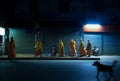 Line of monks collect morning alms