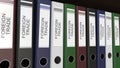 Line of multicolor office binders with Foreign trade tags 3D rendering