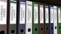 Line of multicolor office binders with Insurance cases tags 3D rendering