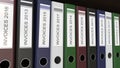 Line of multicolor office binders with Invoices tags different years 3D rendering Royalty Free Stock Photo