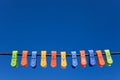 Line of multicolor plastic clothes pegs