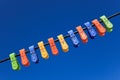 Line of multicolor plastic clothes pegs