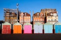 A line of 7 multicoloured beach huts on Brighton promenade in t